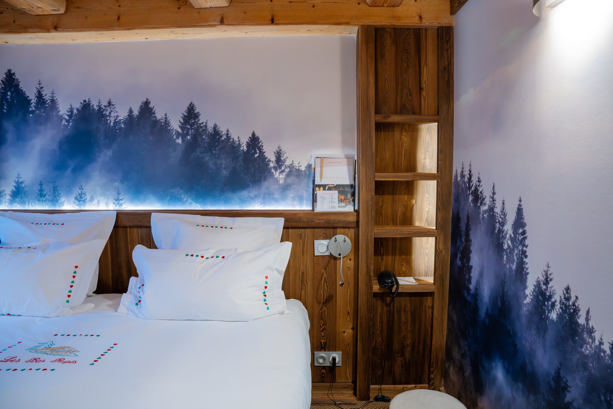 Junior Suite at Les Bas Rupts hotel featuring a bedroom, separate living area, modern bathroom, and a terrace with forest views.